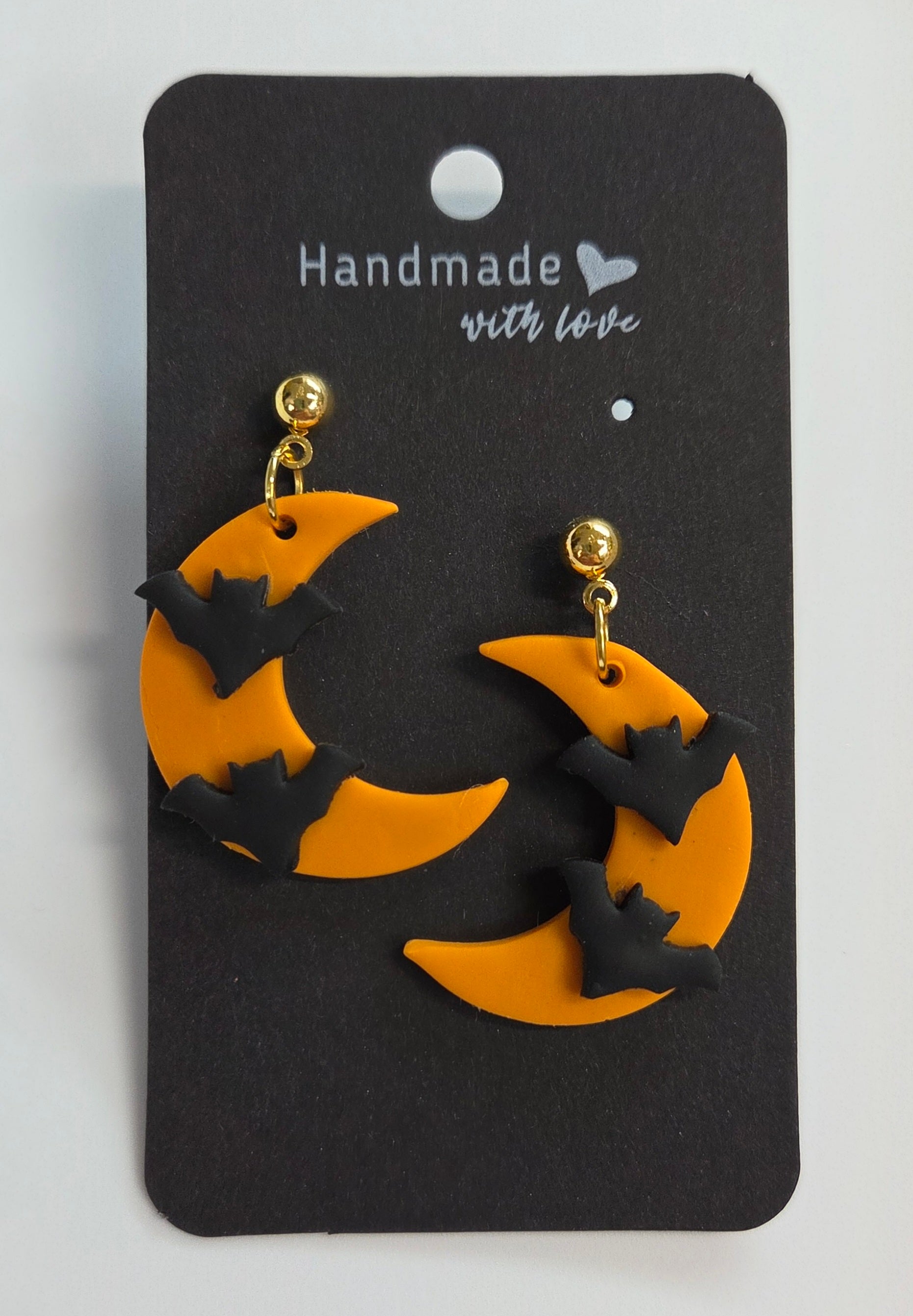 2 Black Bats flying on a half Orange Moon!