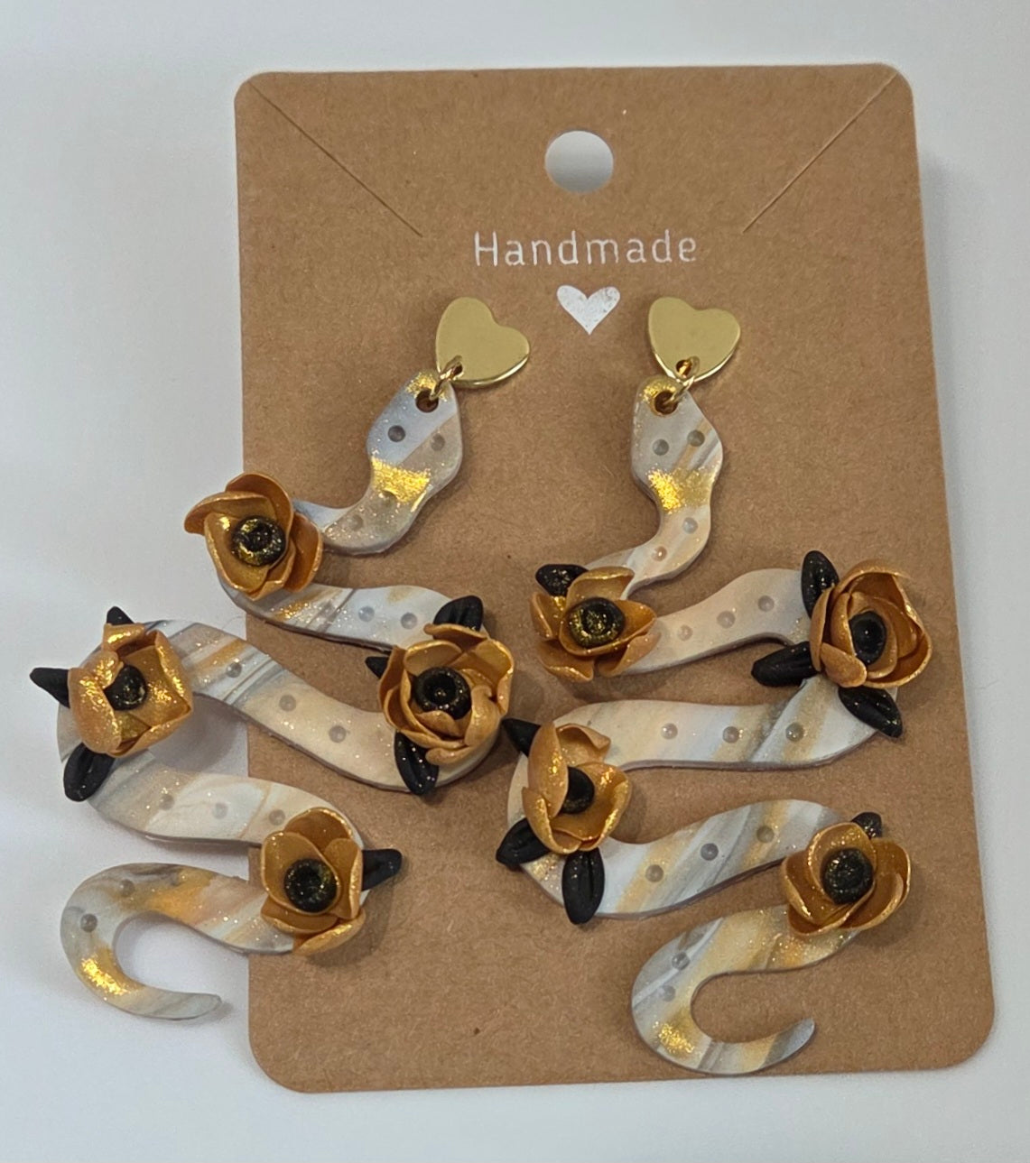 LARGE STUD SNAKE EARRINGS WITH GOLDEN FLOWERS AND BLACK LEAFS
